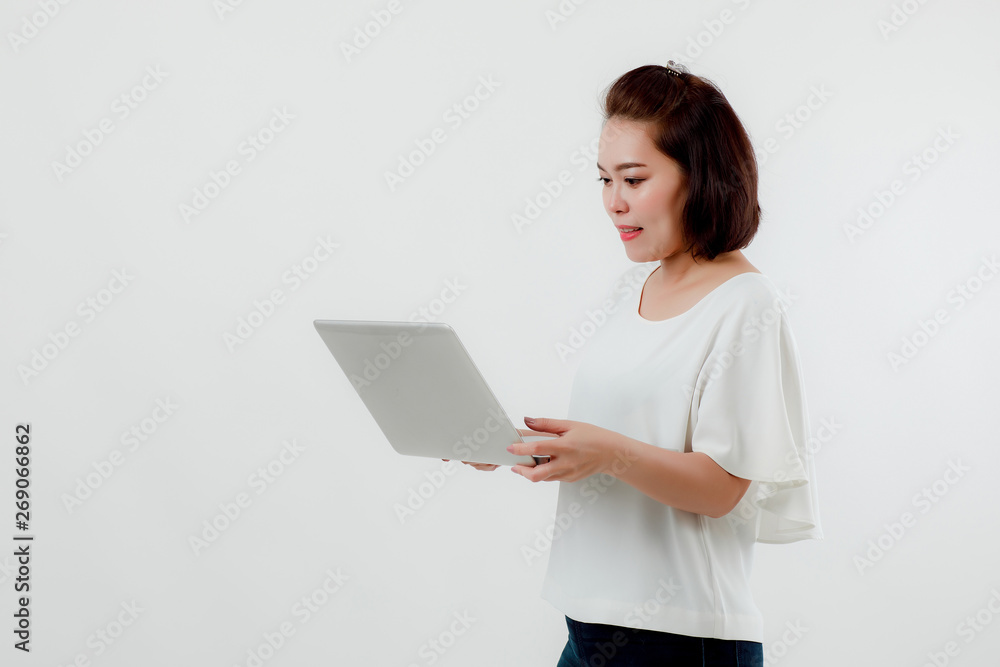 Asian beautiful woman Standing in a white shirt in her hand Holding a laptop computer Stand smiling happily With a white background Asian beautiful woman Standing in a white shirt in her hand Holding a laptop computer Stand smiling happily With a white background