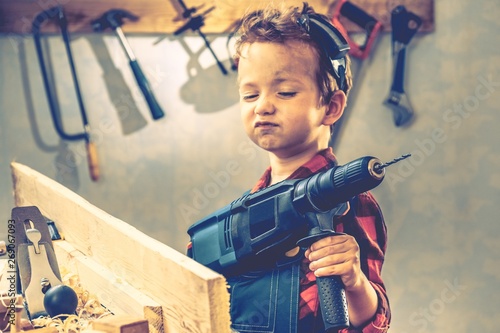 Child fathers day concept, carpenter tool,  worker. photo