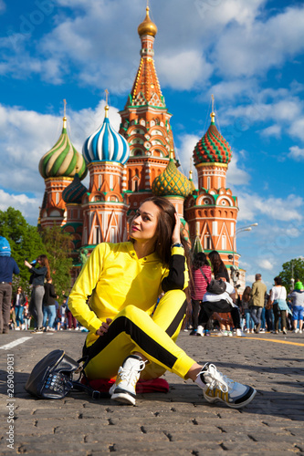 Canvas Print Portrait of a young beautiful brunette woman in yellow tracksuit