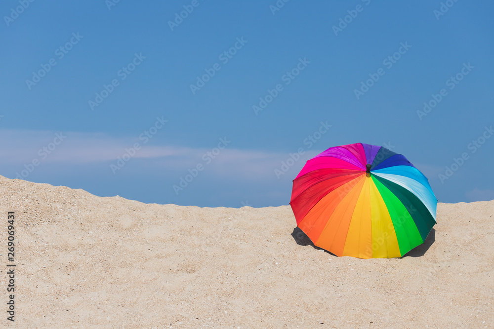 Colorful umbrellas on the beach and the blue sky