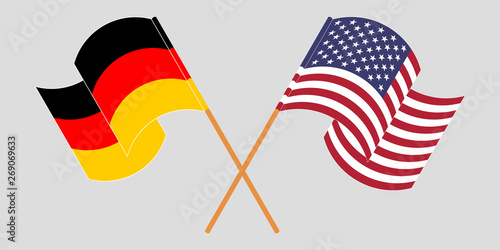 Crossed and waving flags of Germany and the USA