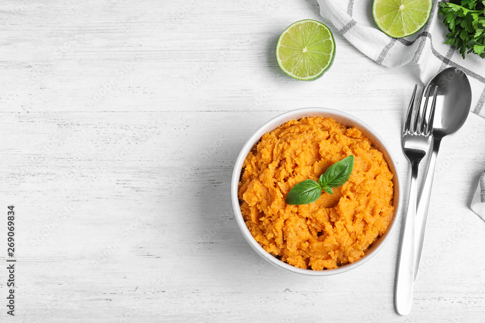 Flat lay composition with mashed sweet potatoes on wooden background, space for text Flat lay composition with mashed sweet potatoes on wooden background, space for text