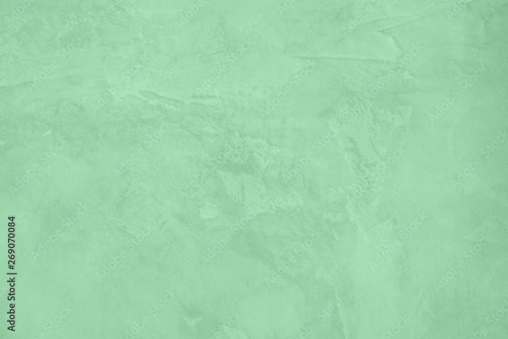 Trendy Neo mint colored low contrast Rough Concrete textured background to your concept or product. Color of the year 2020