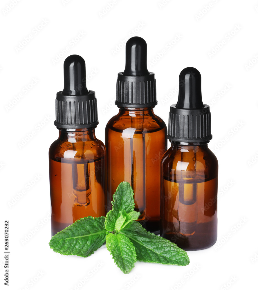 Different bottles of essential oils and mint on white background Different bottles of essential oils and mint on white background