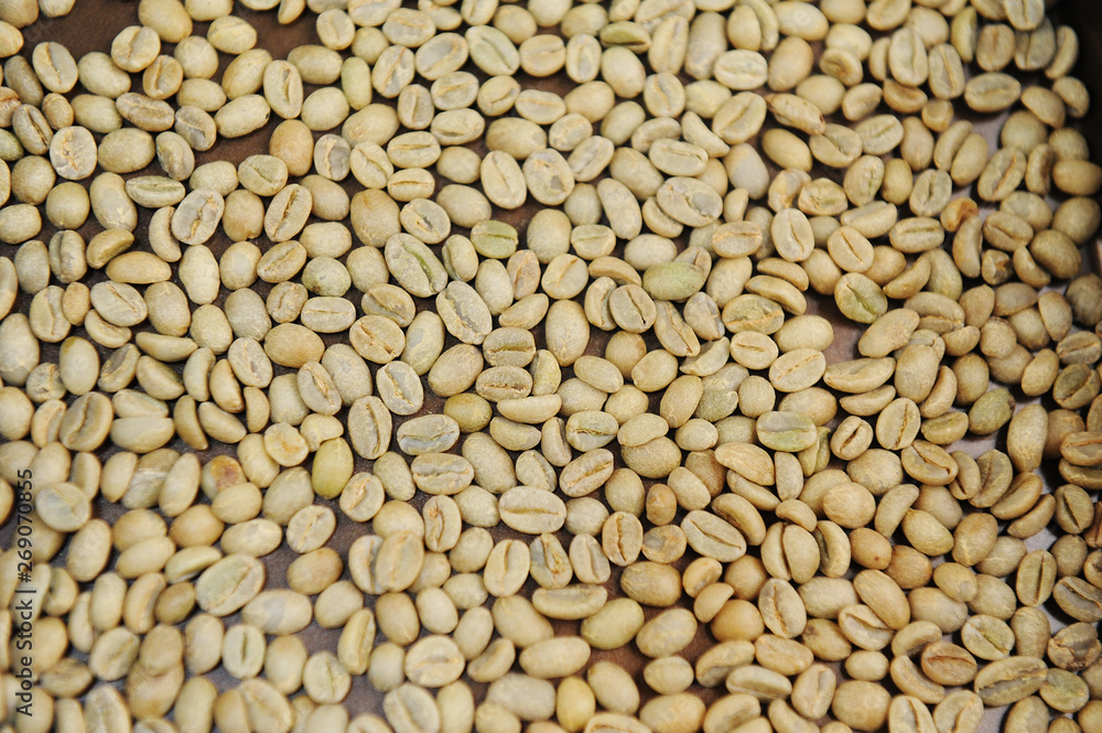 Raw unroasted green coffee beans. Top view texture Raw unroasted green coffee beans. Top view texture
