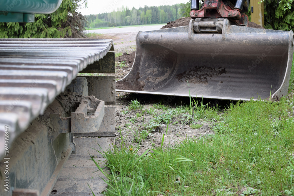 Excavator close up. Focus on shovel. Copy space. Excavator close up. Focus on shovel. Copy space.