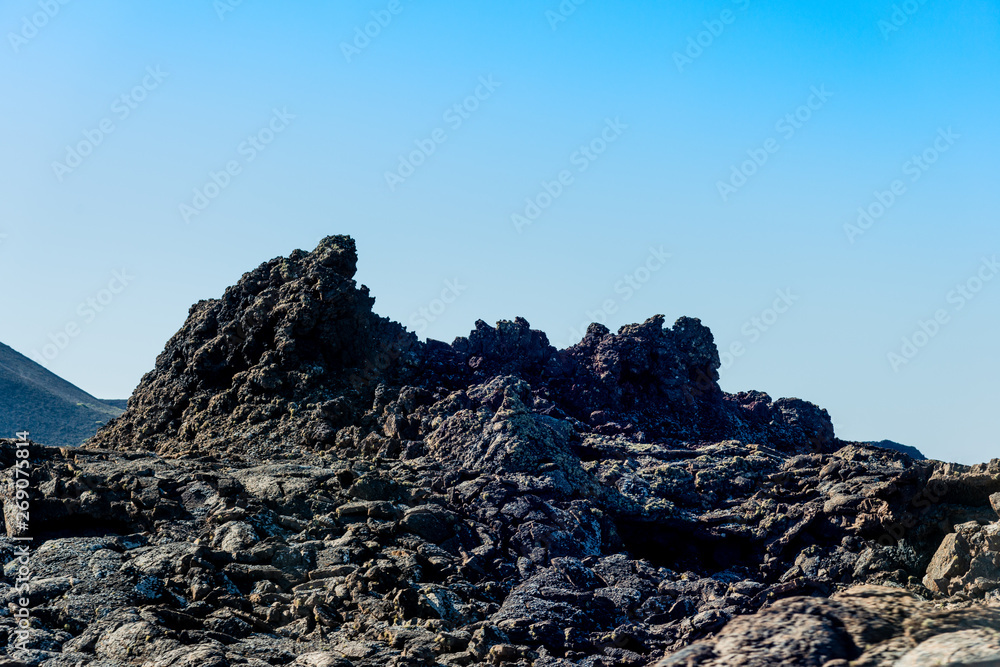 Timanfaya National Park, mountains of fire at Lanzarote, Canary Islands, Spain. Unique panoramic view of spectacular lava river flows from a huge volcano crater. Timanfaya National Park, mountains of fire at Lanzarote, Canary Islands, Spain. Unique panoramic view of spectacular lava river flows from a huge volcano crater.