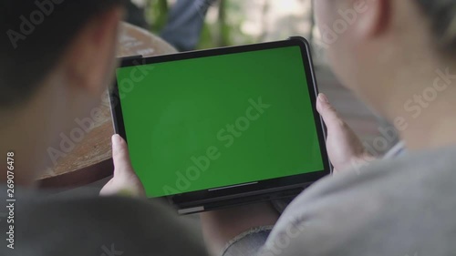 Mother and Son using digital tablet together, Green screen chroma key.