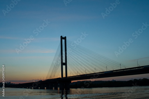  silhouette of a bridge at sunset © EvhKorn