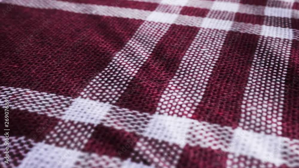 Burgundy white tablecloth, picnic gingham is waving. Close up macro shot checkered claret red fabric cloth background. Burgundy white tablecloth, picnic gingham is waving. Close up macro shot checkered claret red fabric cloth background.