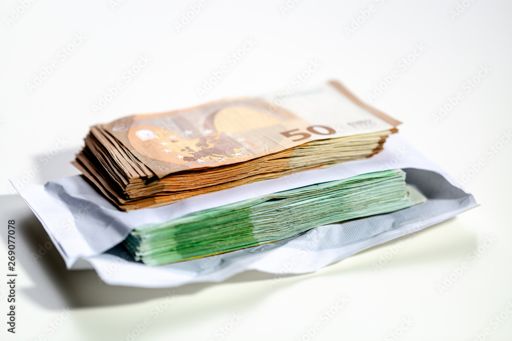 Euro banknotes put in an envelope. A large amount of money with a shallow depth of field. Euro banknotes put in an envelope. A large amount of money with a shallow depth of field.