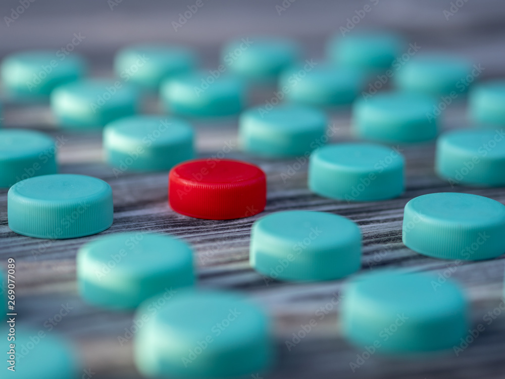 Image of different colored plastic caps on wooden background Image of different colored plastic caps on wooden background