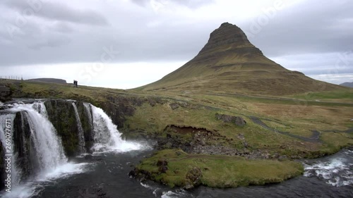 beautiful kirkjufell mountain in iceland with waterfall and clouds