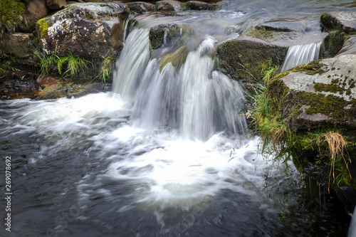 Small waterfall tumbling over rocky edge