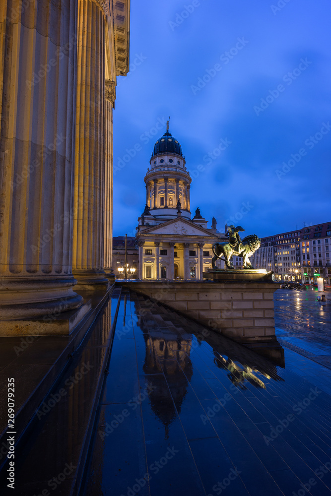 Illuminated Konzerthaus Berlin (Berlin Concert Hall) and Französischer Dom (French Cathedral) at the Gendarmenmarkt Square in Berlin, Germany, in the evening.