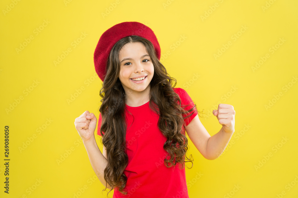 Lucky and beautiful. Kid girl long healthy shiny hair wear red hat. Little girl with long hair. Kid happy cute face adorable curly hair yellow background. Beauty tips for tidy hair. Smiling child Lucky and beautiful. Kid girl long healthy shiny hair wear red hat. Little girl with long hair. Kid happy cute face adorable curly hair yellow background. Beauty tips for tidy hair. Smiling child