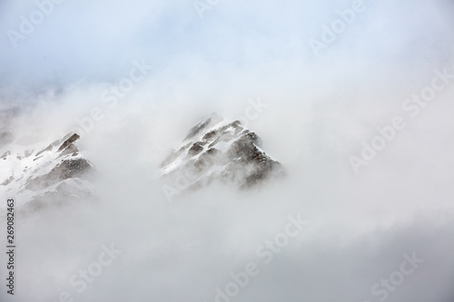 Alps peaks are covered by clouds.