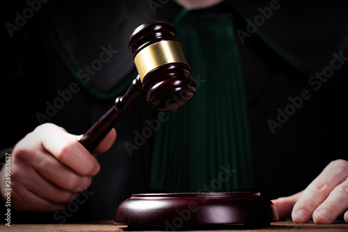 judge hits the gavel and pronunces final judgement. Law and justice concept photo