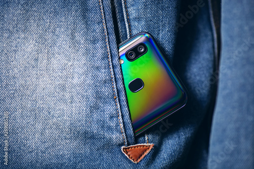 smartphone with dual camera lens on the jeans pocket photo