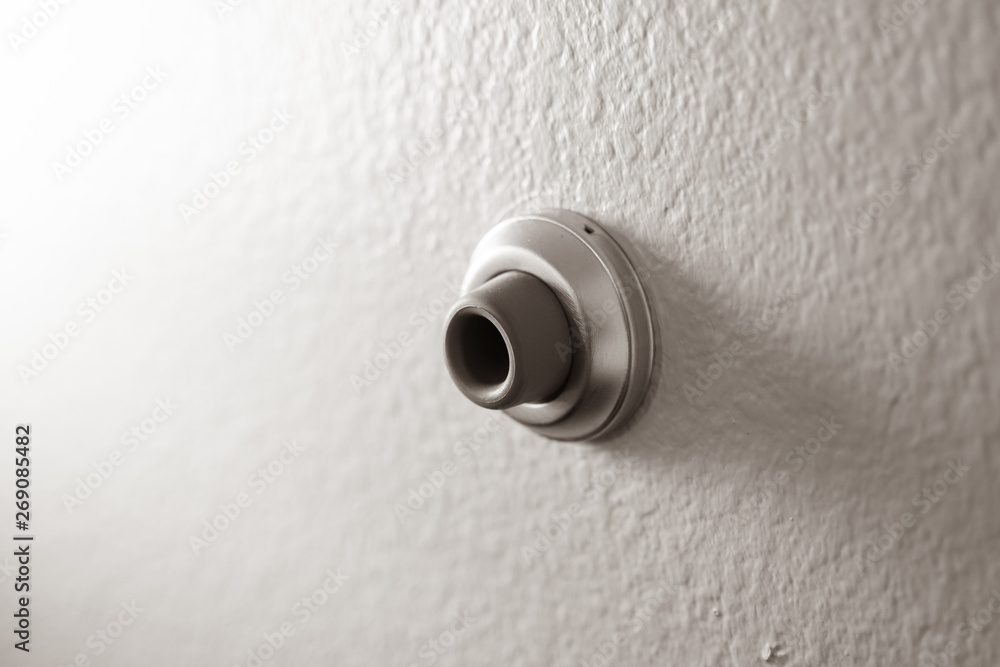 Isolated, close up of a wall mounted door stop, to prevent a door from damanging the wall when shut Isolated, close up of a wall mounted door stop, to prevent a door from damanging the wall when shut