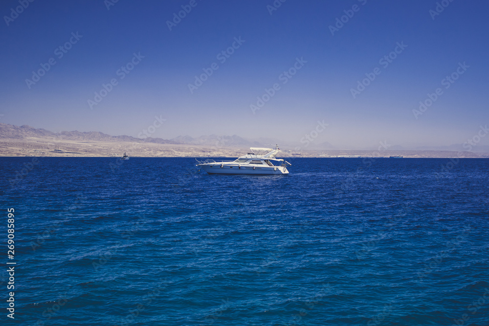 summer season nature seaside scenic landscape and small white yacht on Red sea water surface for cruise vacation rest spending time