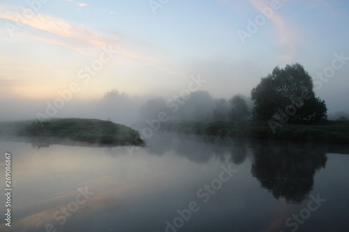 Misty beautiful summer morning on the calm river