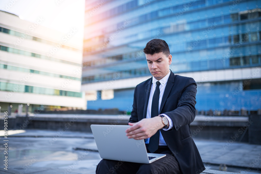Young manager using lap top outside Young manager using lap top outside