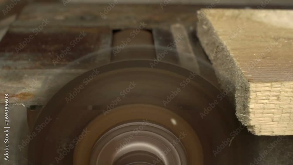 cutting a wooden board on a circular slow motion cutting a wooden board on a circular slow motion