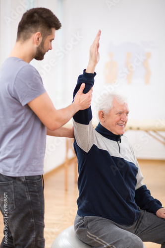 Foto Senior man exercising and recovering at nursing center after heart attack