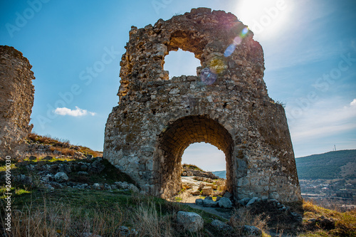 Ruins of ancient and abandoned fortress or tower or castle or fort Calamita in Inkerman, Sevastopol, Crimea. Medieval historic stone building on mountain