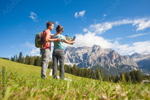 Travelers hiking in breathtaking landscape of Dolomites Mounatins in summer in ALta Badia, Italy.