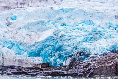 At the edge of the blue shining glacier Nordenskiöldbreen near Pyramiden, on the coast of Billefjord, Svalbard. Norway © Beautyness