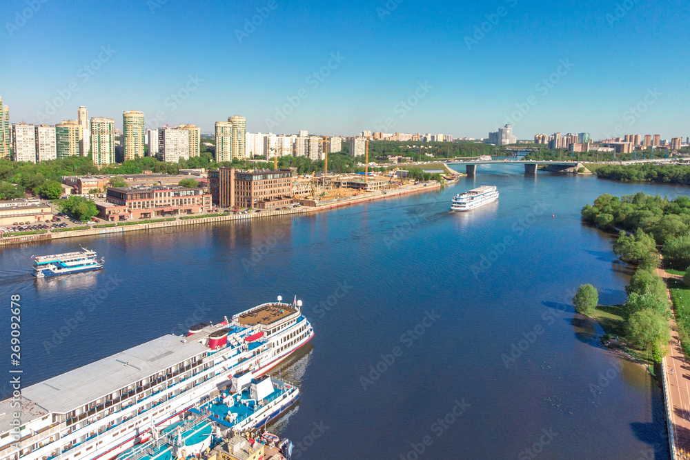 Scenic view of the city by the river with ships sailing on it. Concept clean city, life in the city. aerial shot, top shot