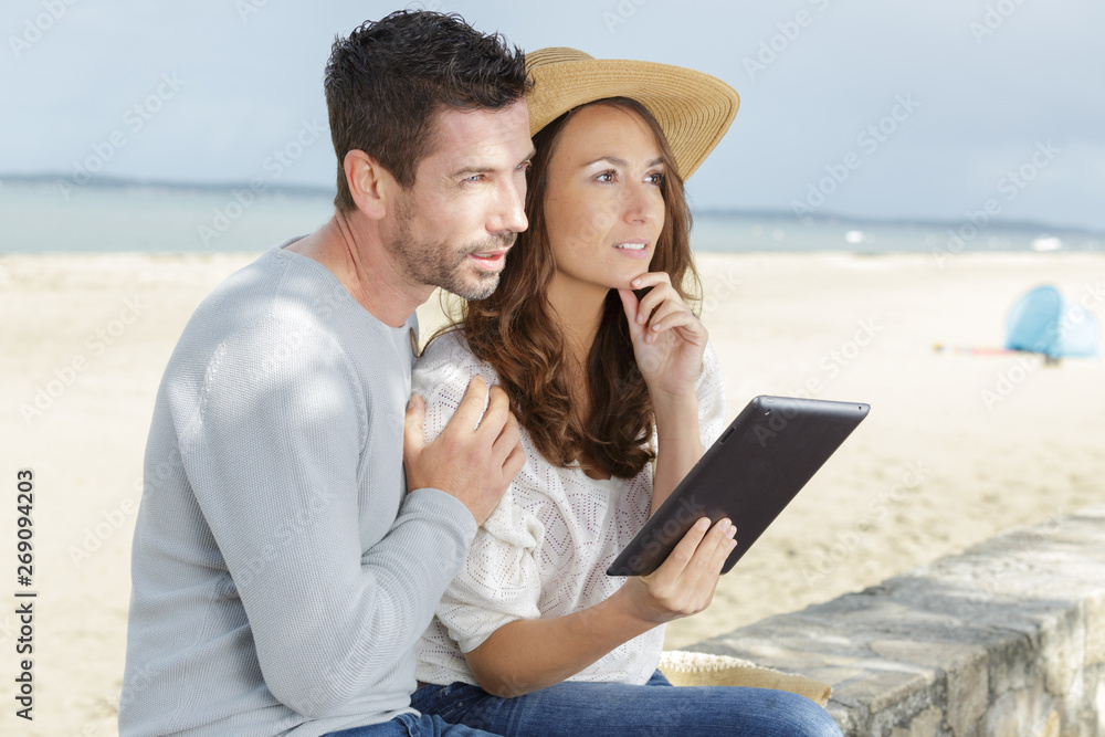 couple having their holidays looking for boat tickets online