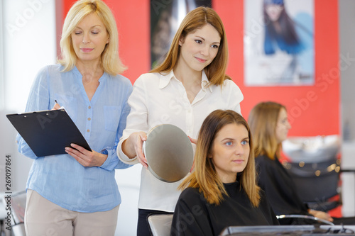 hairdresser finishing womans hair syle