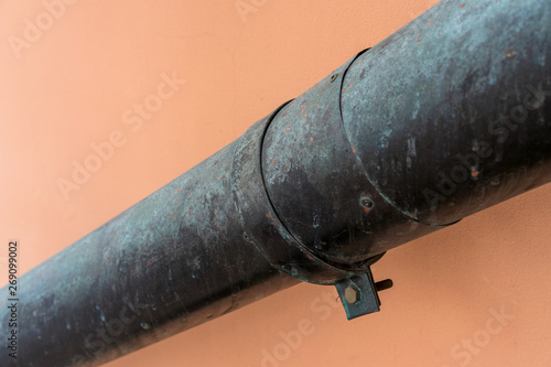 drain pipe with hose clamp on the wall