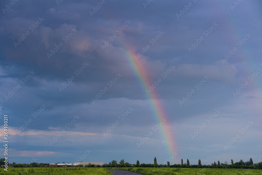 spectacular rainbow in the sky in front of the building site spectacular rainbow in the sky in front of the building site