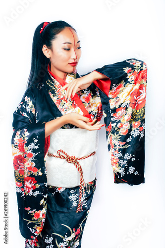 young pretty real geisha in kimono with sakura and decoration on white background isolated © iordani