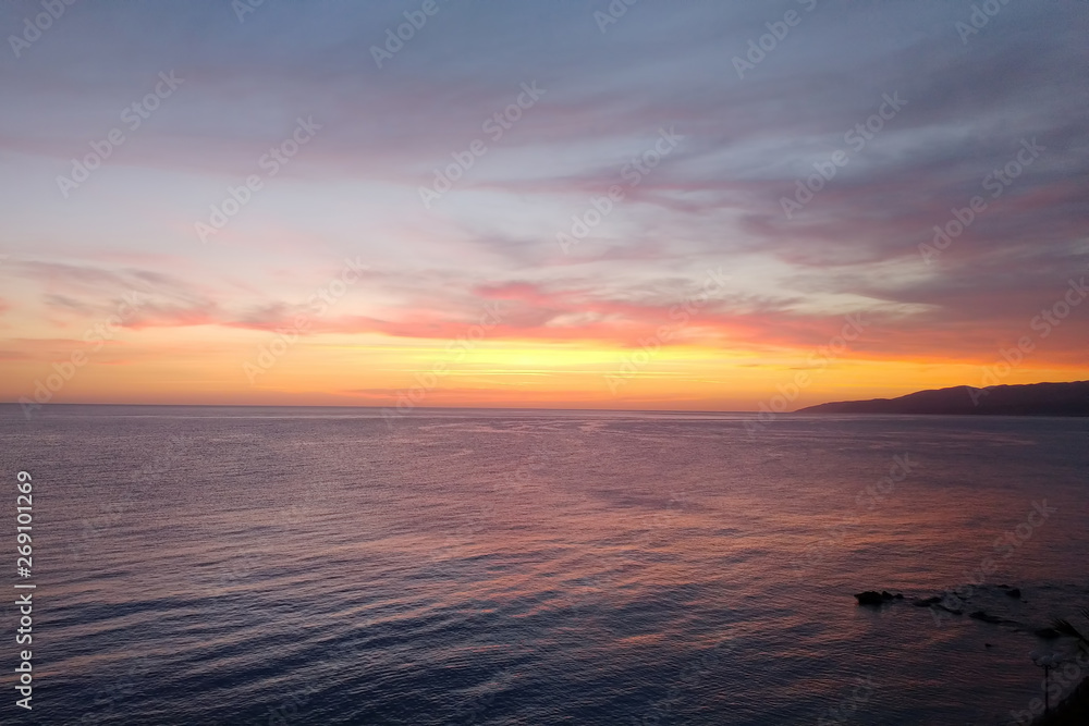 Pink Golden sunset on the sea. View from second floor of building near the beach Pink Golden sunset on the sea. View from second floor of building near the beach