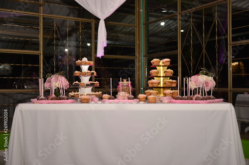 Mesa adornada con cupcakes, duldes, golosinas en fista de 15 años y boda  photo