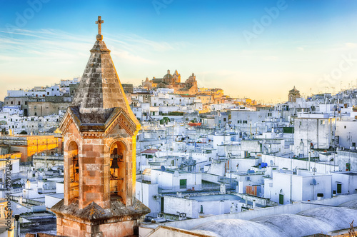 View of old town white town Ostuni and cathedral at sunrise. photo