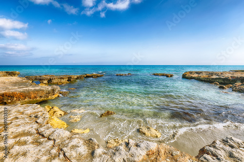 Picturesque seascape with white rocky cliffs  sea bay  islets and faraglioni near by Conca Specchiulla Beach