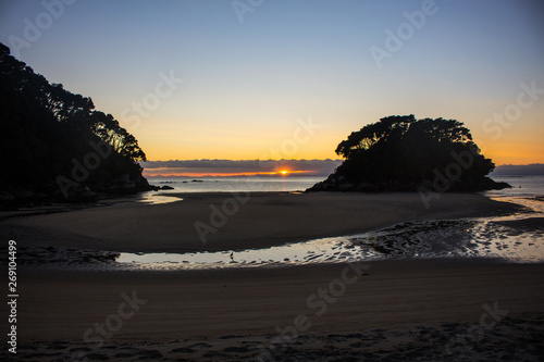 Sunrise on the beach, Abel Tasman National Park, south island, New Zealand.