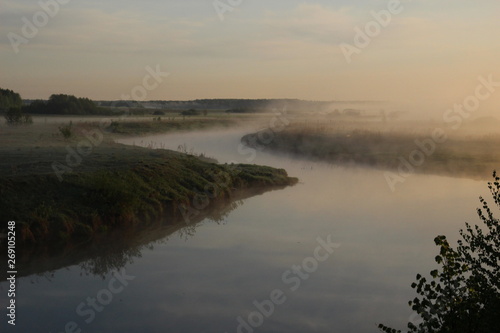 Misty curly river landscape in summer morning