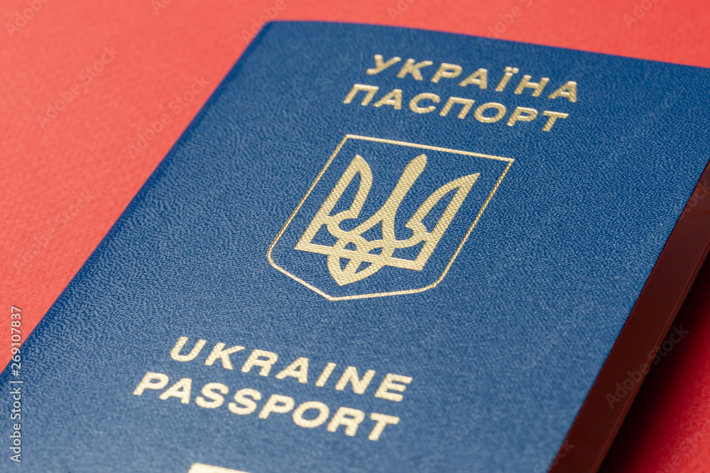 Ukrainian international biometric passport at red paper background. Documents for vacations. Ukrainian international biometric passport at red paper background. Documents for vacations.