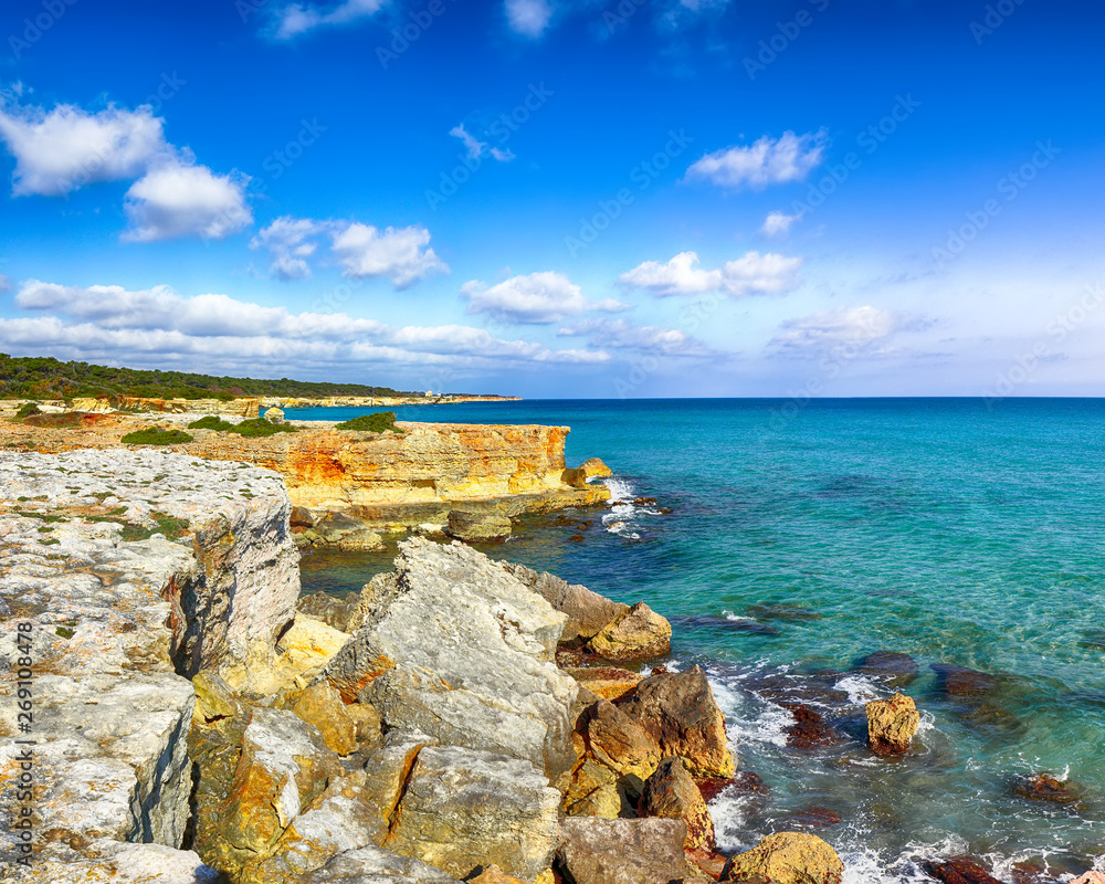 Picturesque seascape with white rocky cliffs, sea bay, islets and faraglioni near by Conca Specchiulla Beach