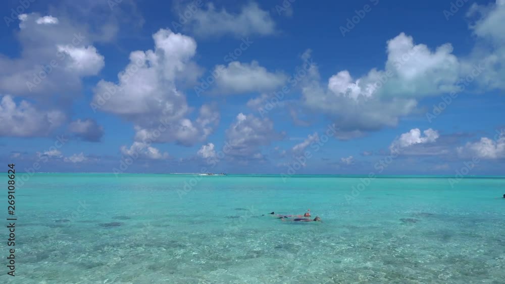 People snorkel in turqoise water near Vaitape, Bora Bora, French Polynesia People snorkel in turqoise water near Vaitape, Bora Bora, French Polynesia