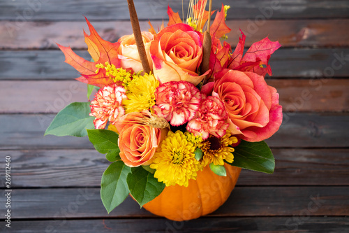 Bouquet of Fall or Thanksgiving flowers with wood background. Autumn flowers.  photo