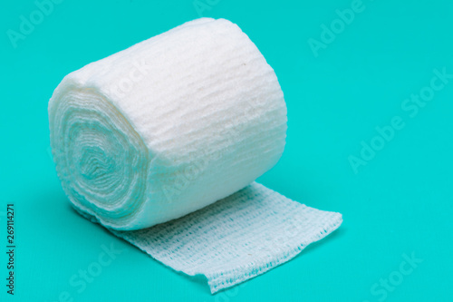 Hospital Grade Sterile Rolled Gauze on green background. photo