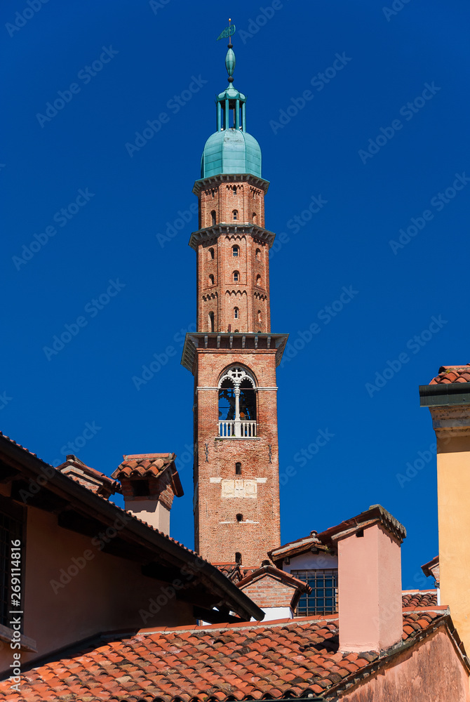 Bissara Tower rises above historic center tradtional red tile roofs and old chimney. Completed in the 15th century, it's the tallest building in Vicenza